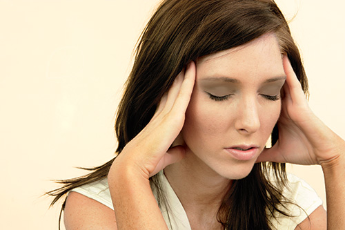 Photo: woman with headache.